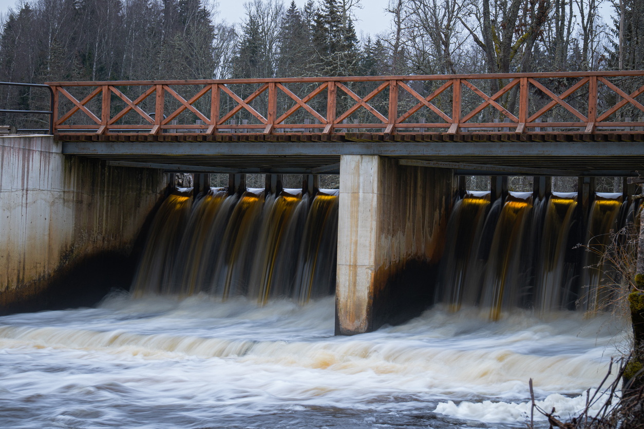 Flowing Water Under Wooden Bridge Dam
